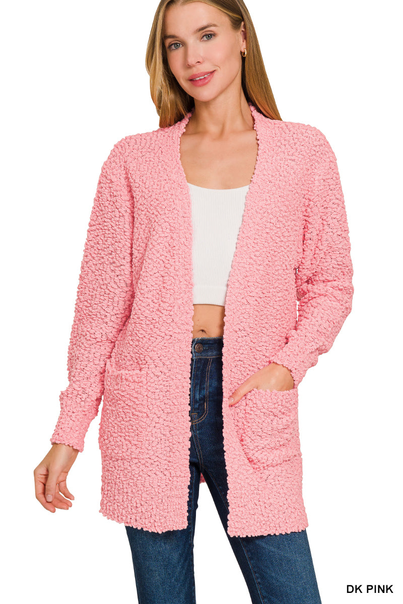 Woman wearing a pink cardigan with text 'DK Pink' on a white background