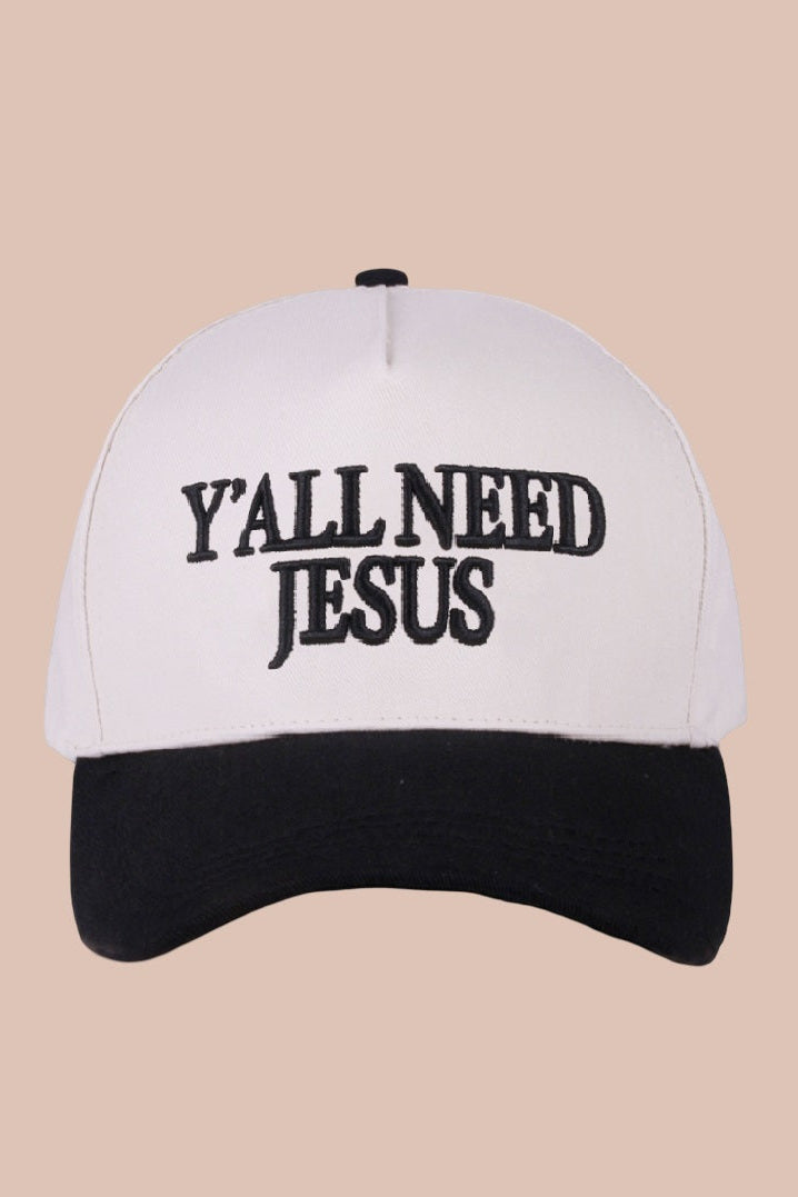 Cap with 'Y'all Need Jesus' text on a beige background