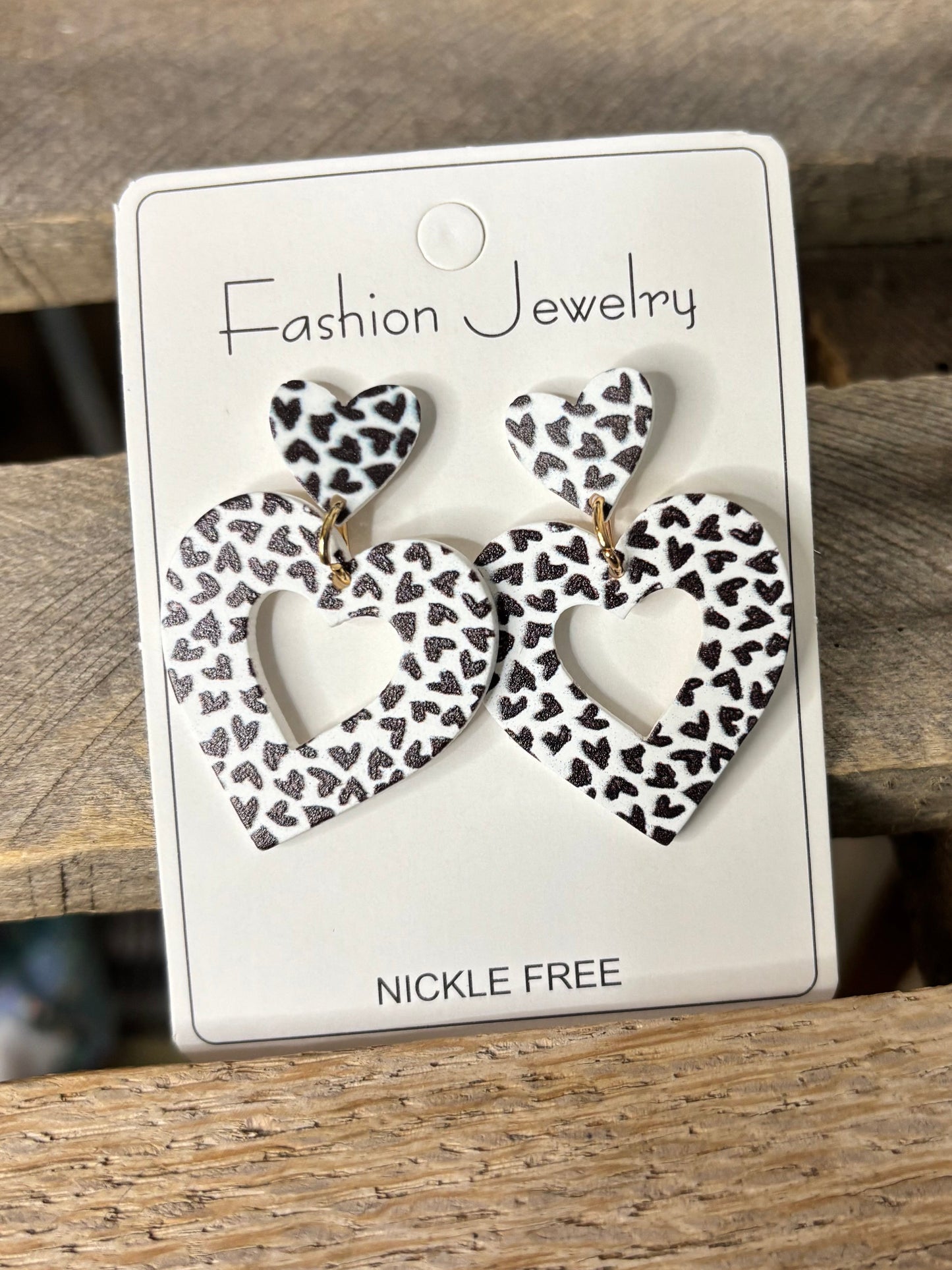 Jewelry card with leopard print earrings on a wooden surface