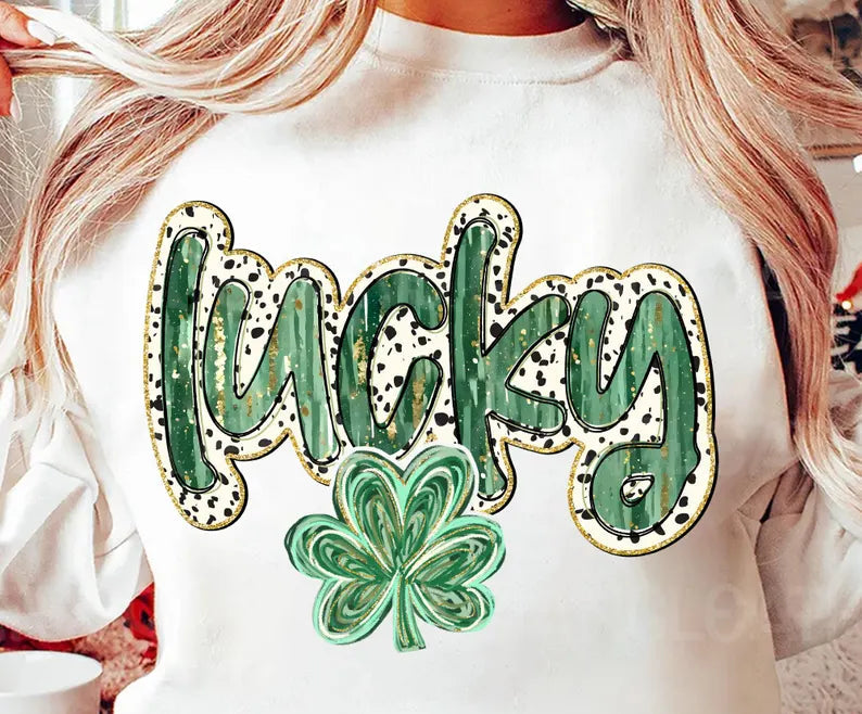 A person wearing a white long-sleeved shirt with the text 'lucky' in green and black, with a four-leaf clover symbol.