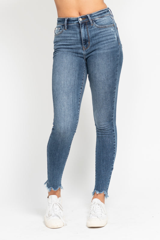 Blue jeans worn by a person on a white background