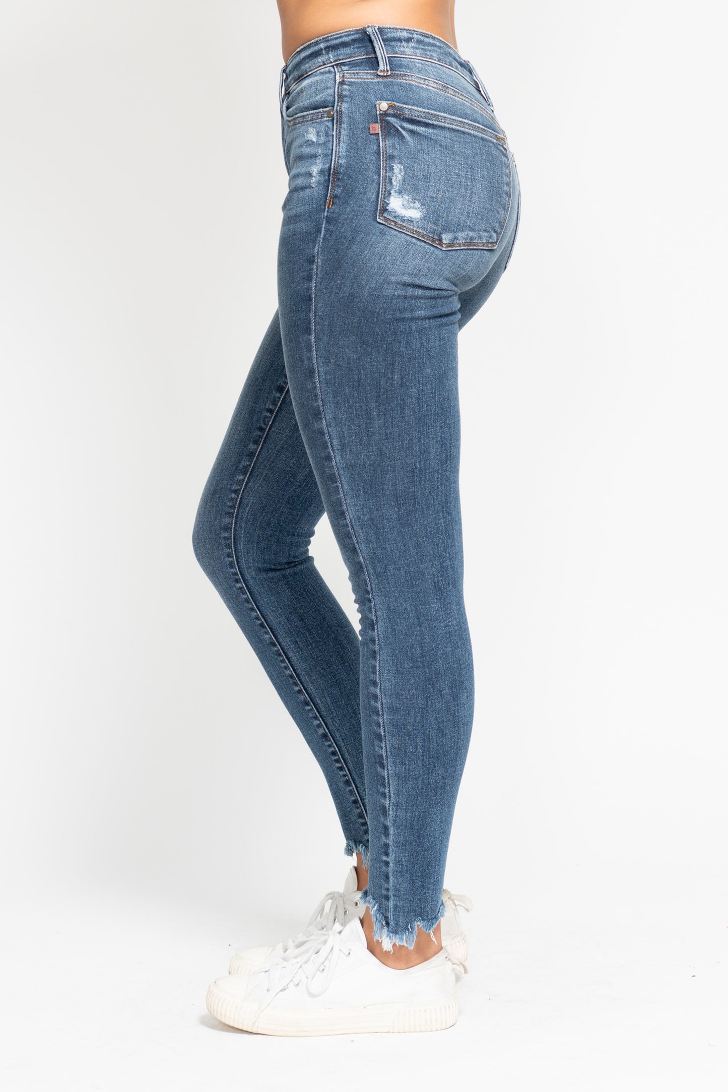 Blue jeans worn by a person on a white background
