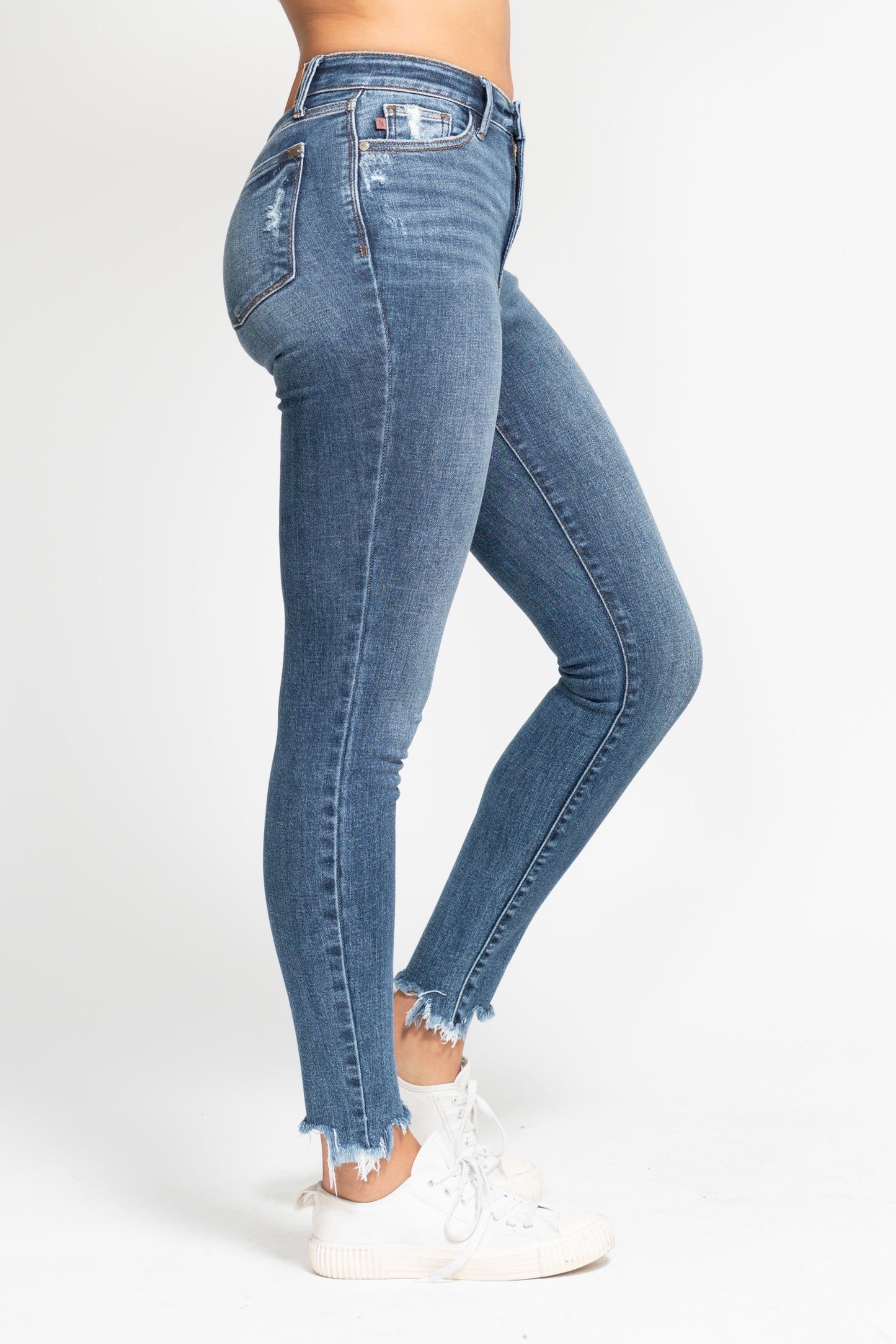 Blue jeans worn by a person on a white background