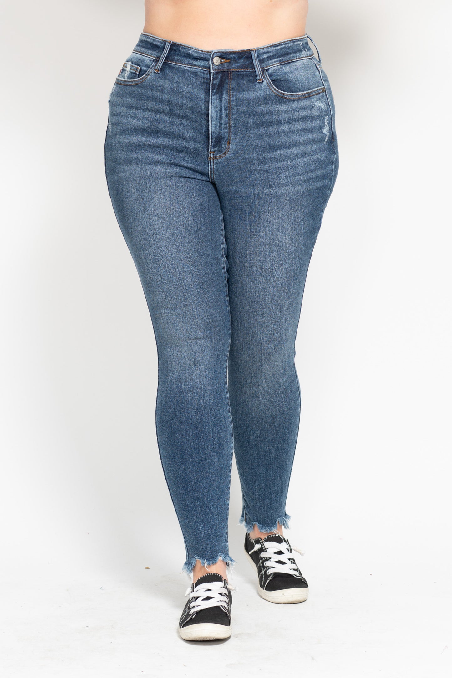 Blue jeans worn by a person on a white background
