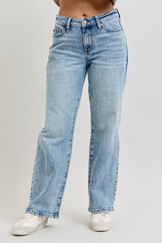 Light blue jeans worn by a person on a plain background