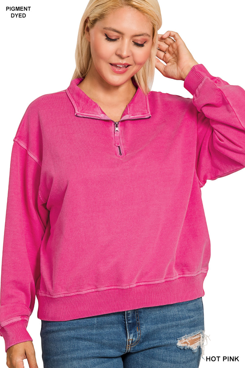 Woman wearing a hot pink pullover with a zipper on a white background