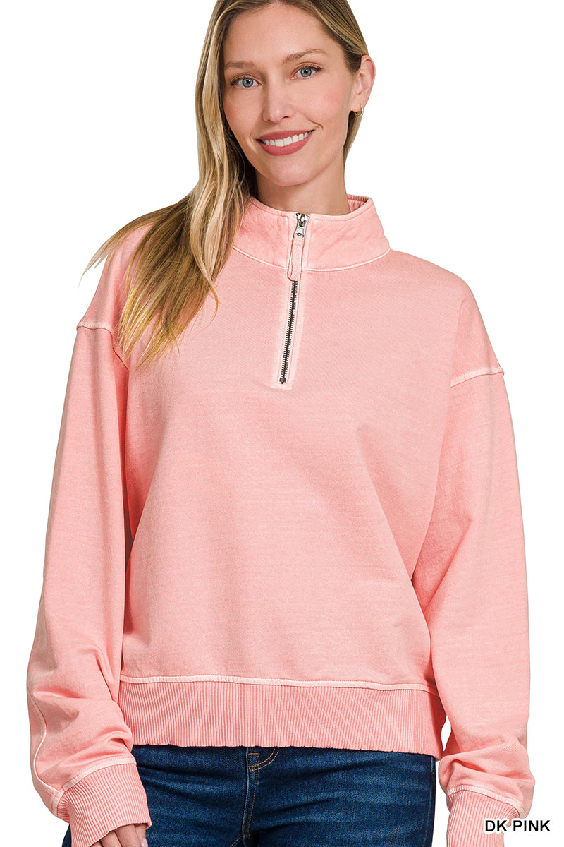 Woman wearing a pink pullover with a zipper on a white background