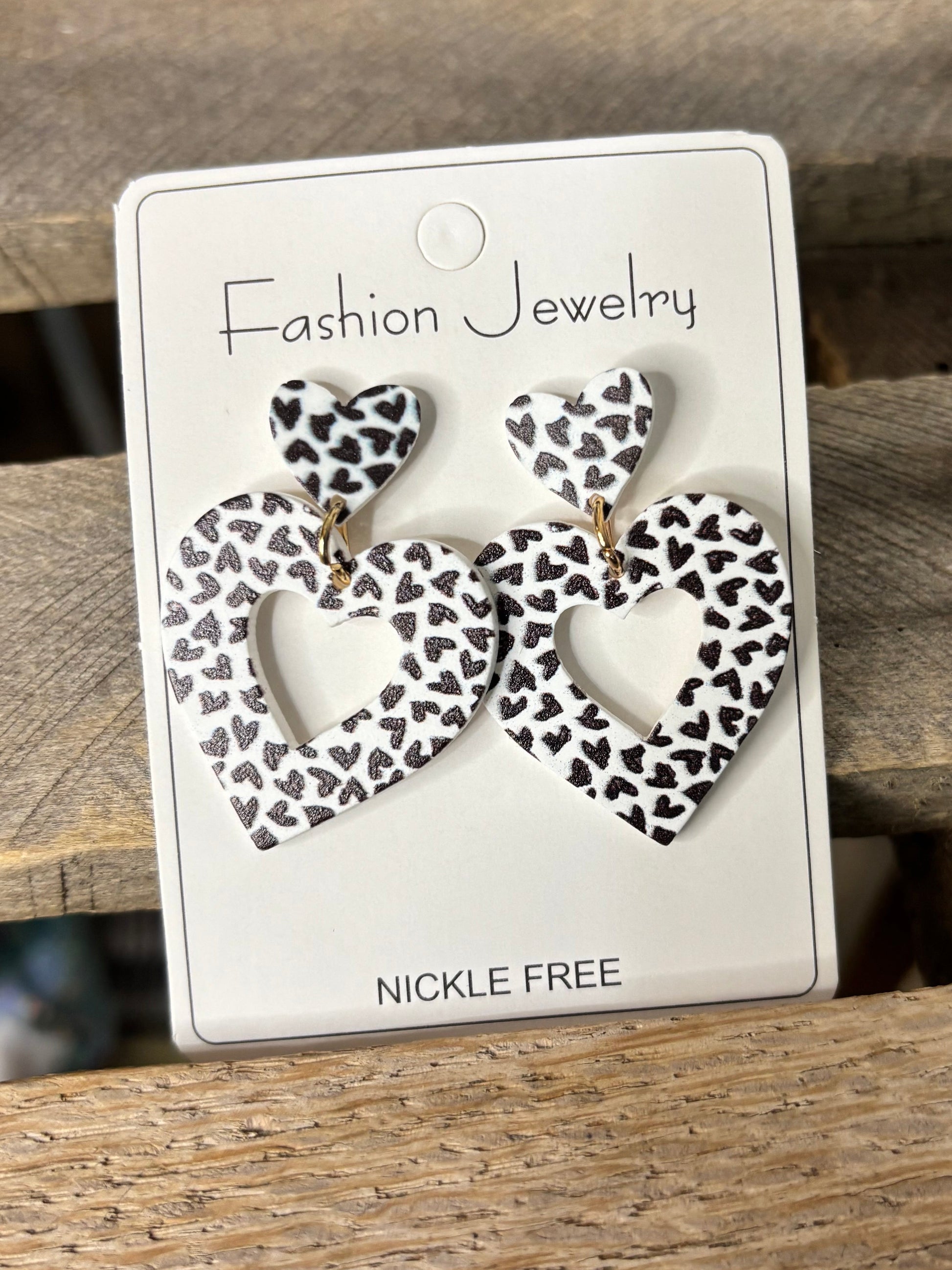 Jewelry card with leopard print earrings on a wooden surface
