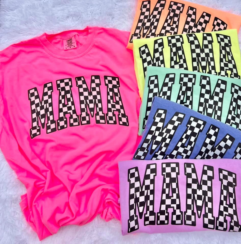 Neon pink t-shirt with 'MAMA' in checkered letters, surrounded by other colorful t-shirts with similar design.